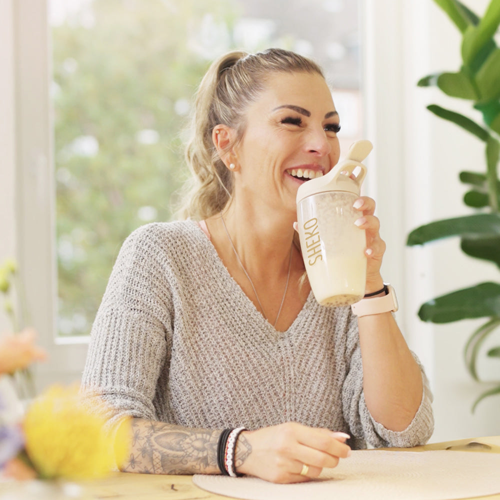 Carina hält ihren Shake lachend