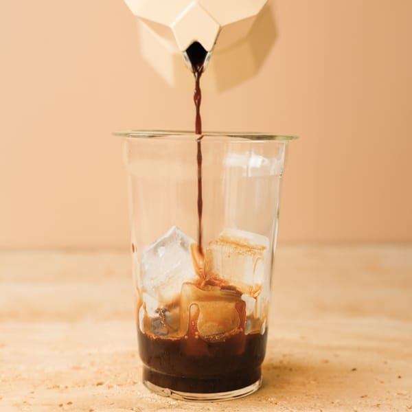 Pour espresso into a glass, add ice cubes.