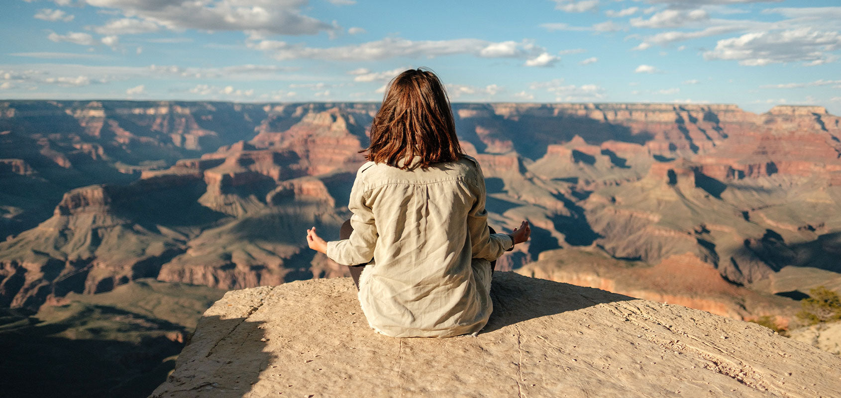 Frau meditiert mit Blick auf Wüstenberge
