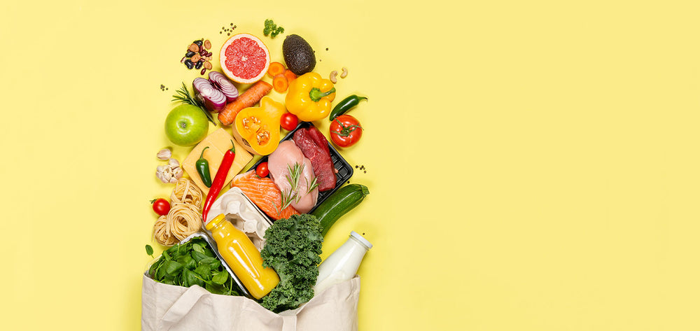 Verschiedenes Gemüse, Obst und Fleisch auf gelbem Hintergrund